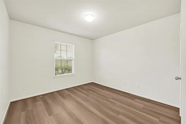 a white toilet sitting next to a white wall