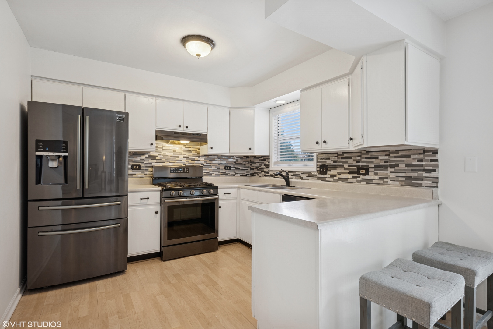 963 Old Oak Circle Algonquin, IL 60102 - Photo 8 of 28 a kitchen with a refrigerator stove and white cabinets