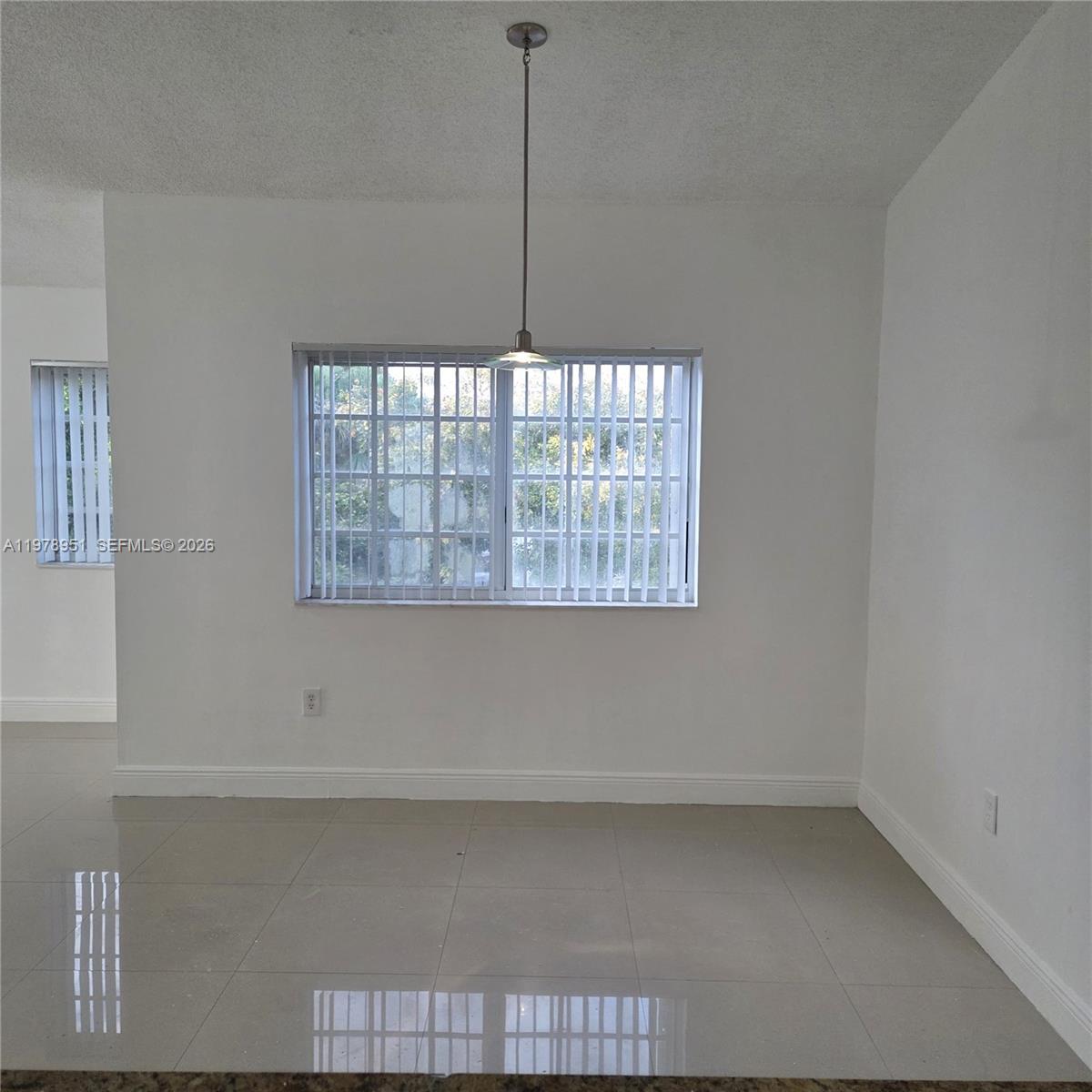 2031 Renaissance Boulevard, Unit 307 Miramar, FL 33025 - Photo 4 of 11 a view of an empty room with a window