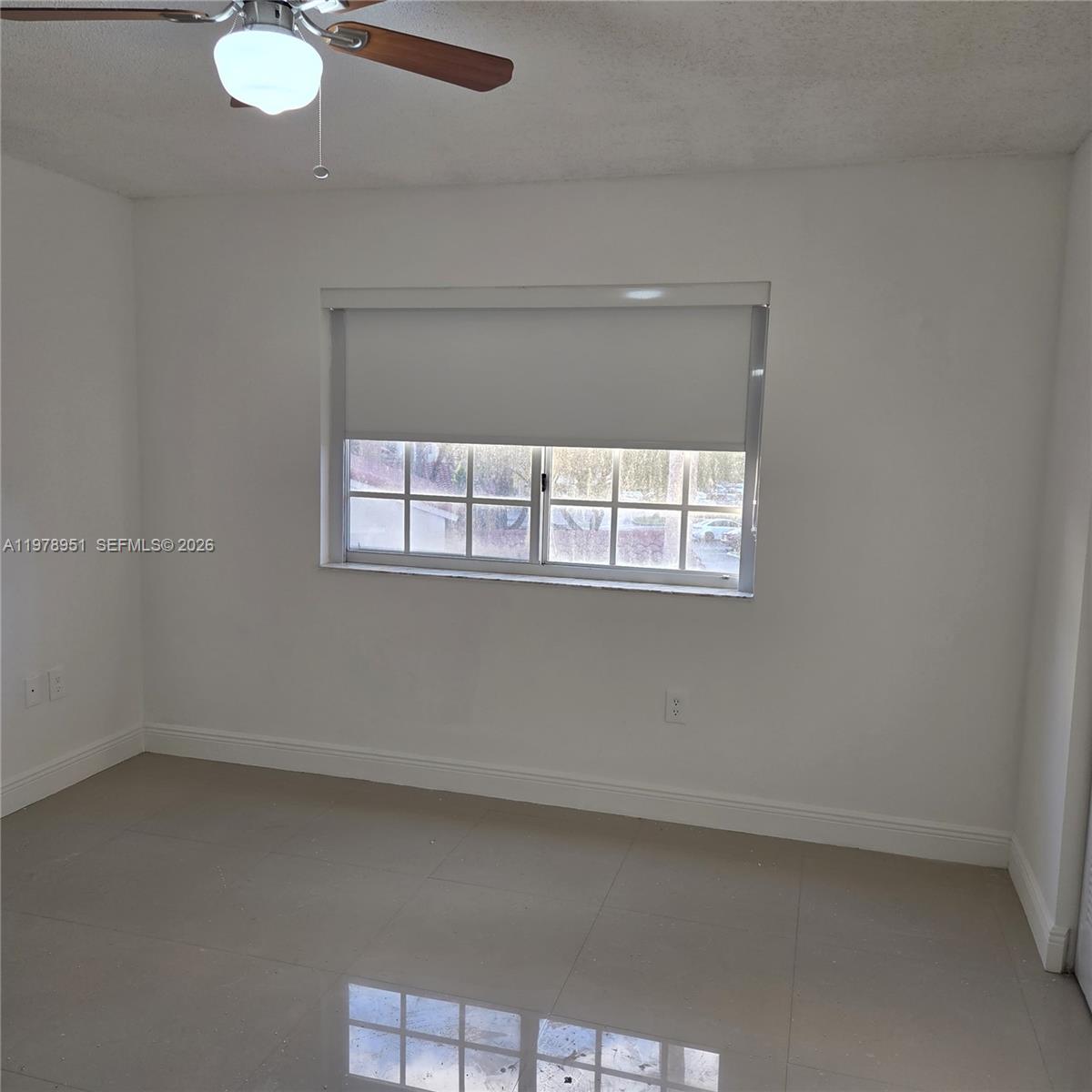 2031 Renaissance Boulevard, Unit 307 Miramar, FL 33025 - Photo 6 of 11 an empty room with a window
