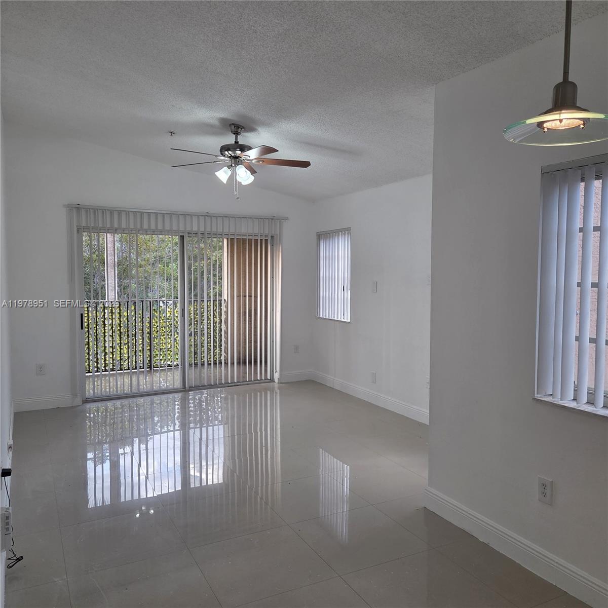 2031 Renaissance Boulevard, Unit 307 Miramar, FL 33025 - Photo 8 of 11 an empty room with windows