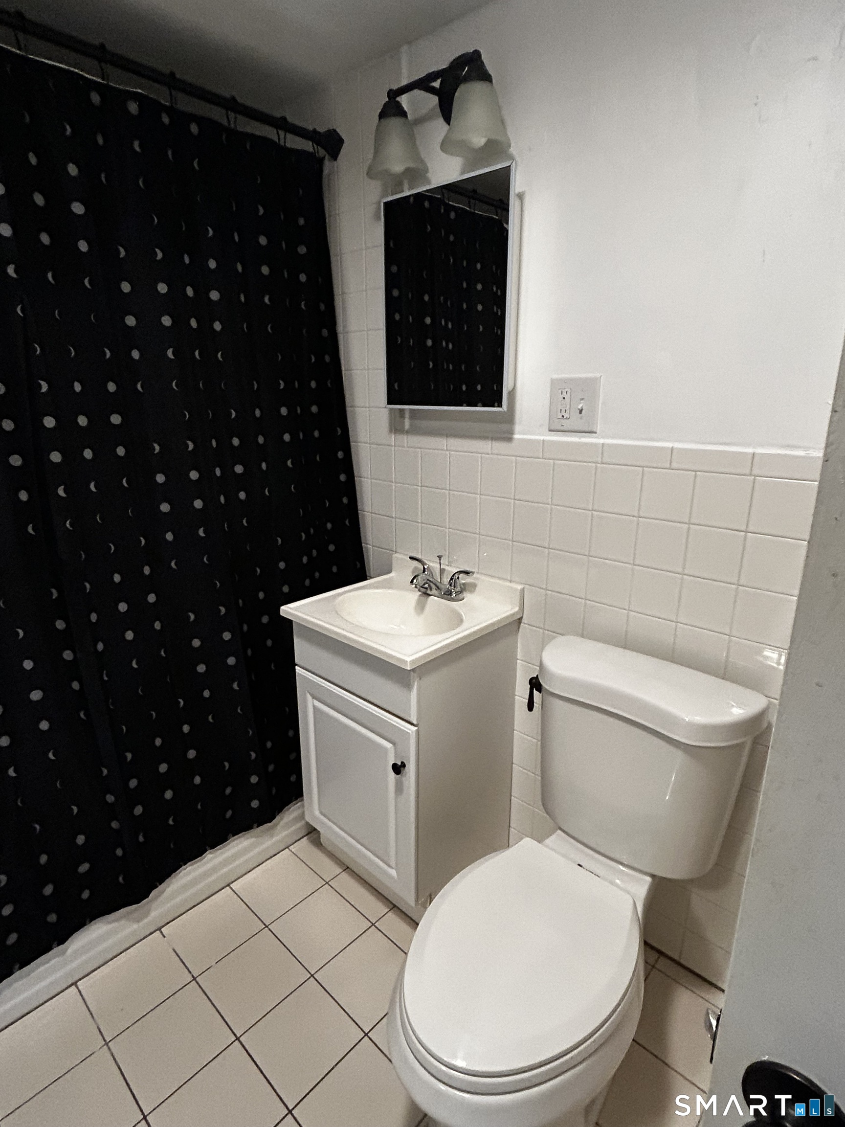 565 Main Street Southington, CT 06489 - Photo 12 of 14 a bathroom with a toilet a sink and a mirror