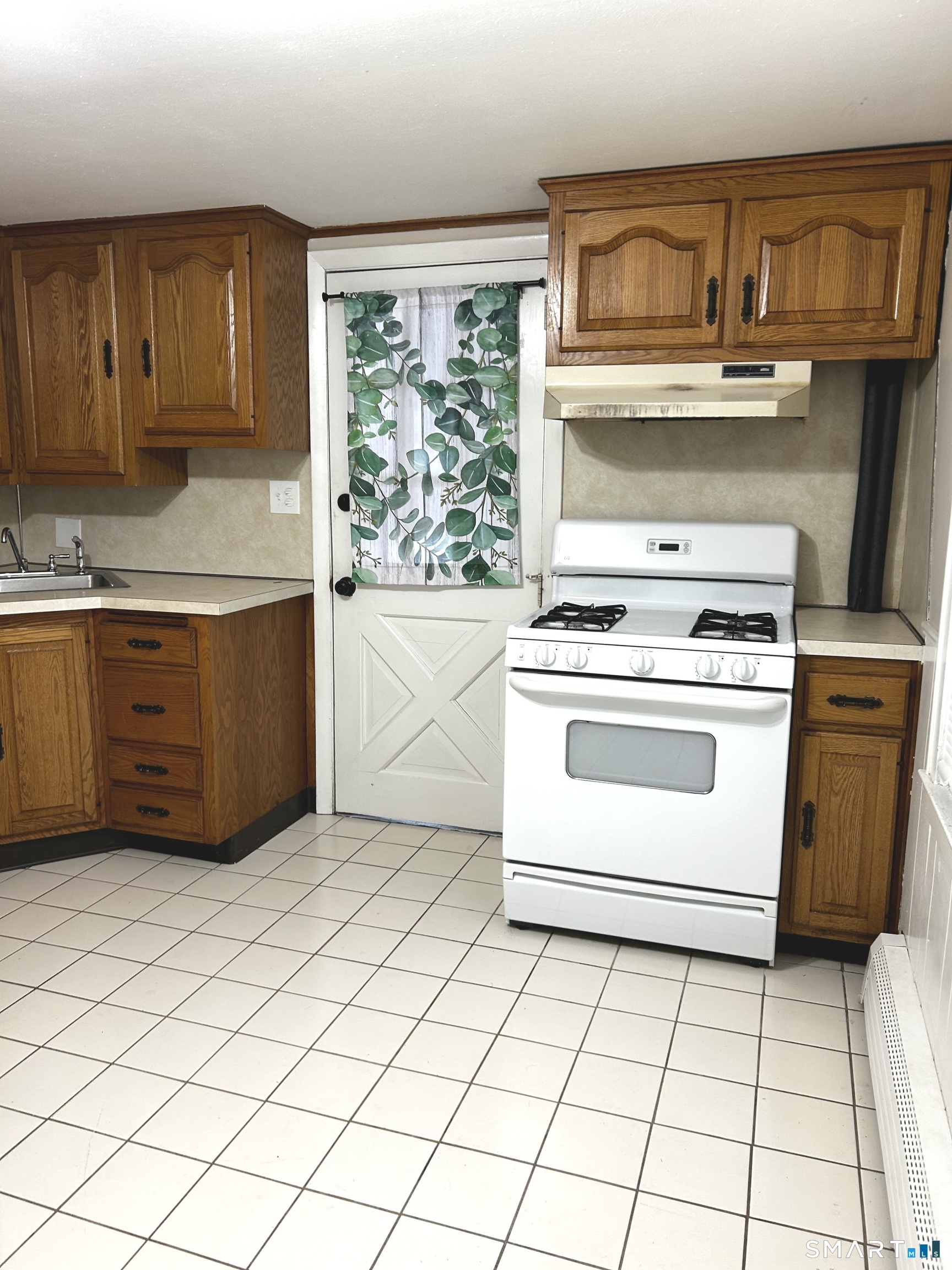 565 Main Street Southington, CT 06489 - Photo 2 of 14 a kitchen with a stove top oven and cabinets