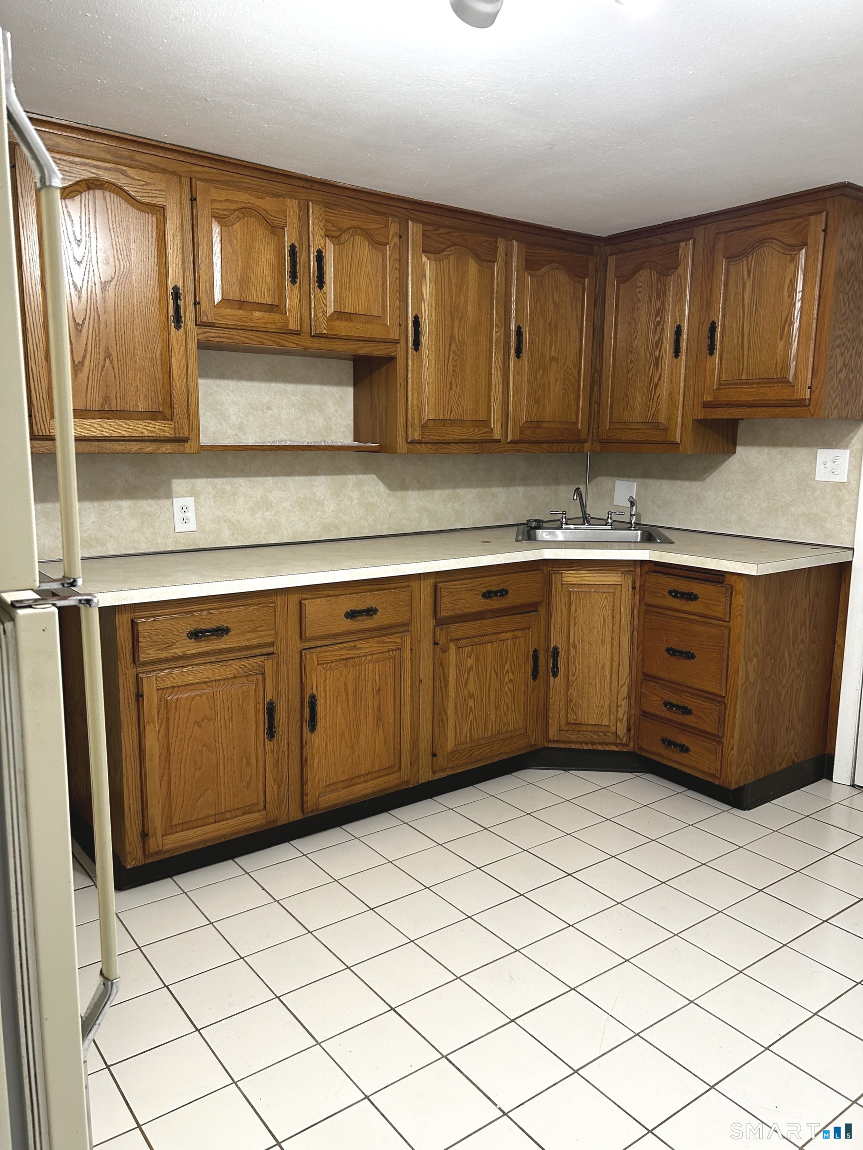 565 Main Street Southington, CT 06489 - Photo 3 of 14 a kitchen with stainless steel appliances granite countertop a sink and cabinets