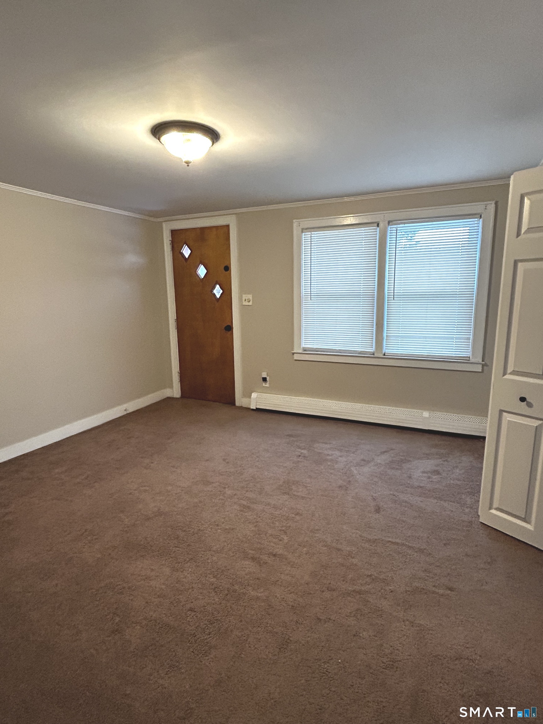 565 Main Street Southington, CT 06489 - Photo 5 of 14 an empty room with wooden floor and windows