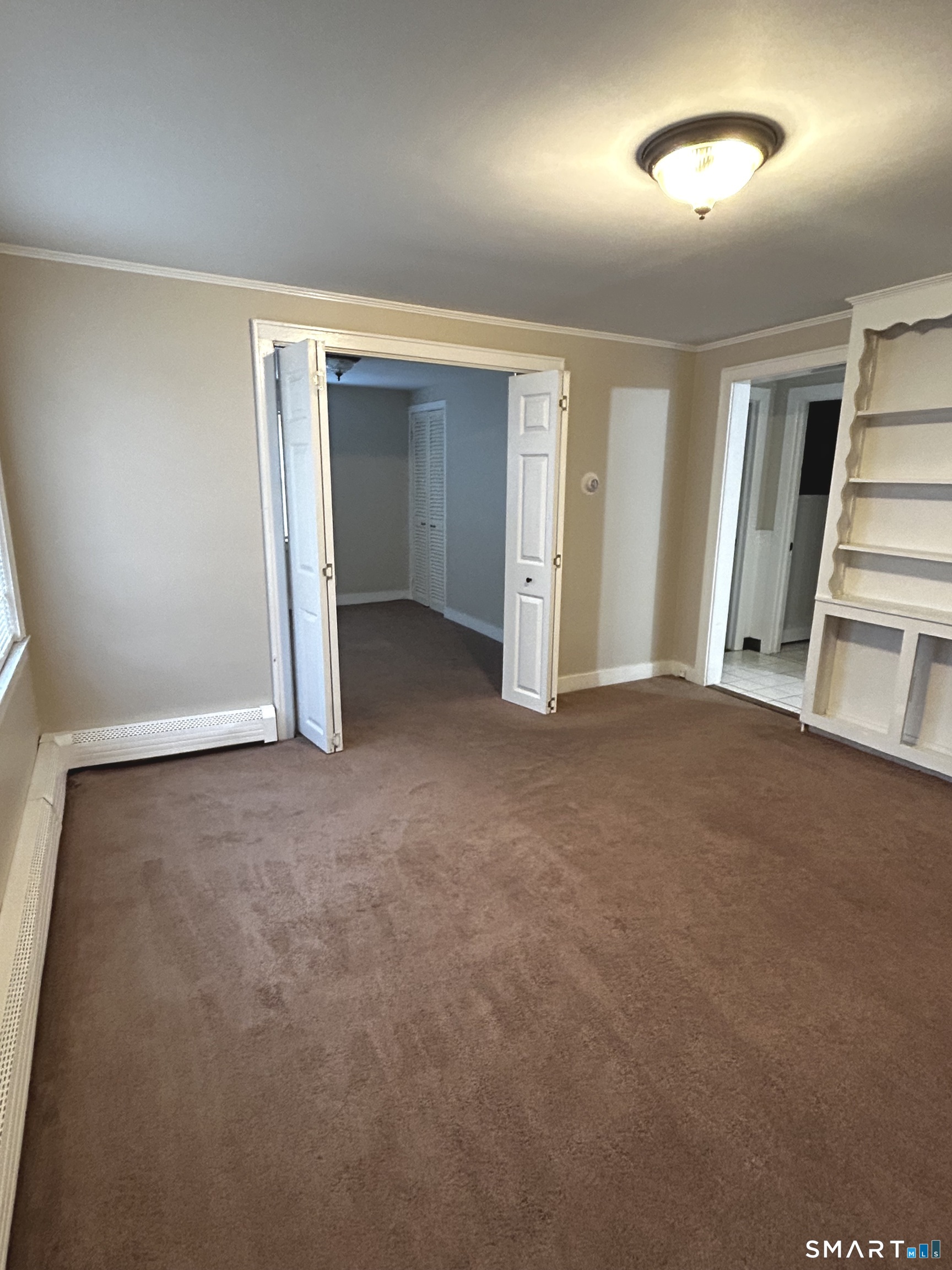 565 Main Street Southington, CT 06489 - Photo 6 of 14 a view of an empty room with a window