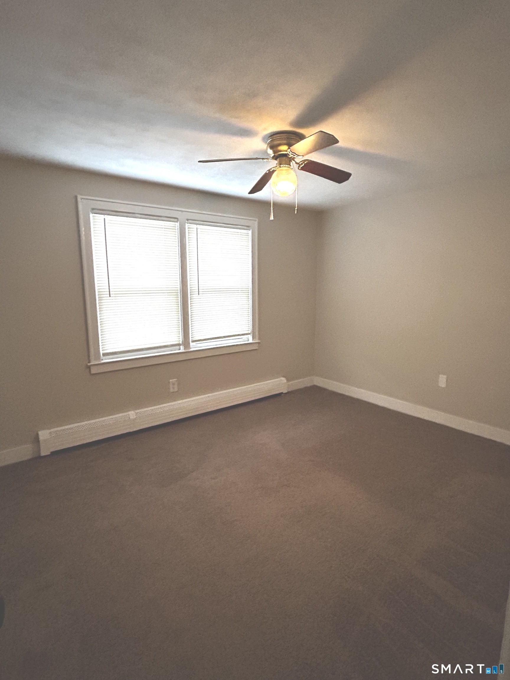565 Main Street Southington, CT 06489 - Photo 9 of 14 an empty room with windows and fan