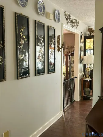 a view of a hallway with wooden floor and windows