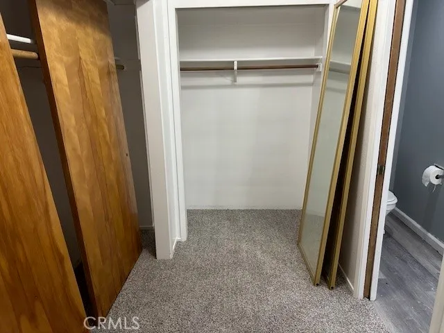a view of closet with wooden floor
