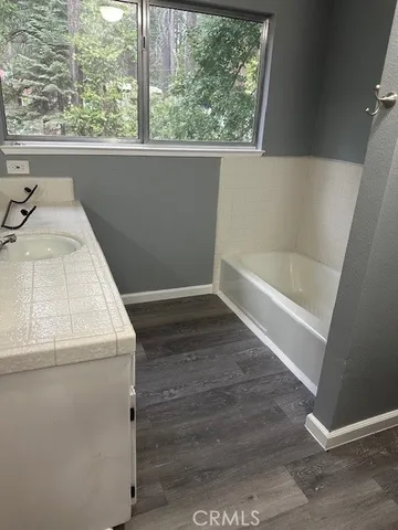 a bathroom with a bathtub and window