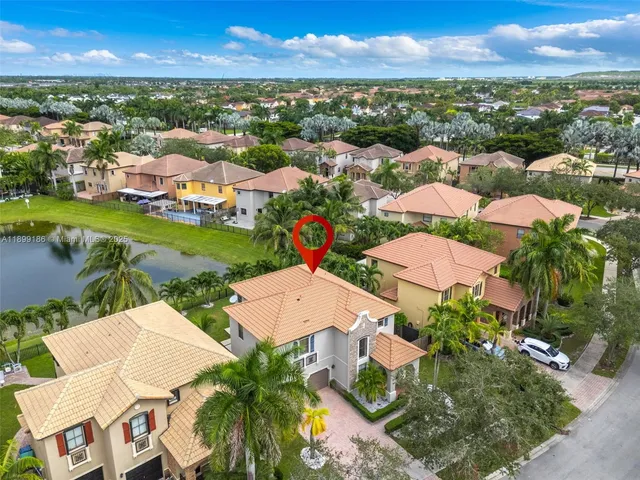 an aerial view of residential houses with outdoor space and river