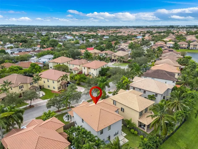 an aerial view of residential houses with outdoor space