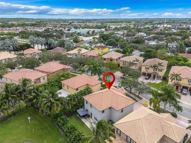 an aerial view of residential houses with outdoor space