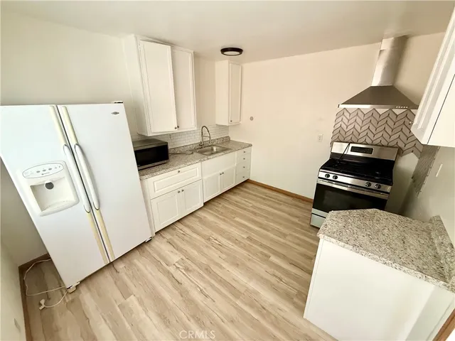 a kitchen with a stove and a refrigerator