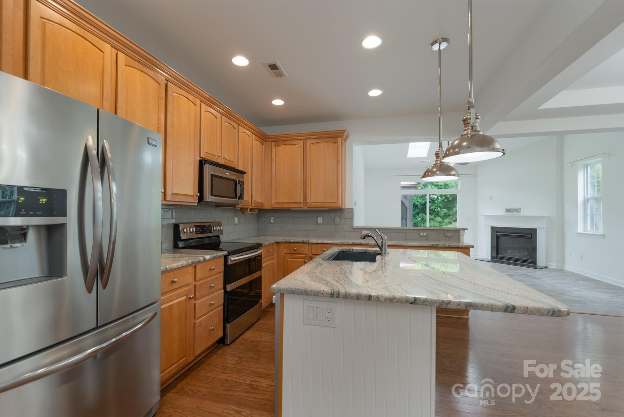 11945 Red Rust Lane Charlotte, NC 28277 - Photo 11 of 41 a kitchen with granite countertop stainless steel appliances a refrigerator a stove a sink cabinets and a dining table
