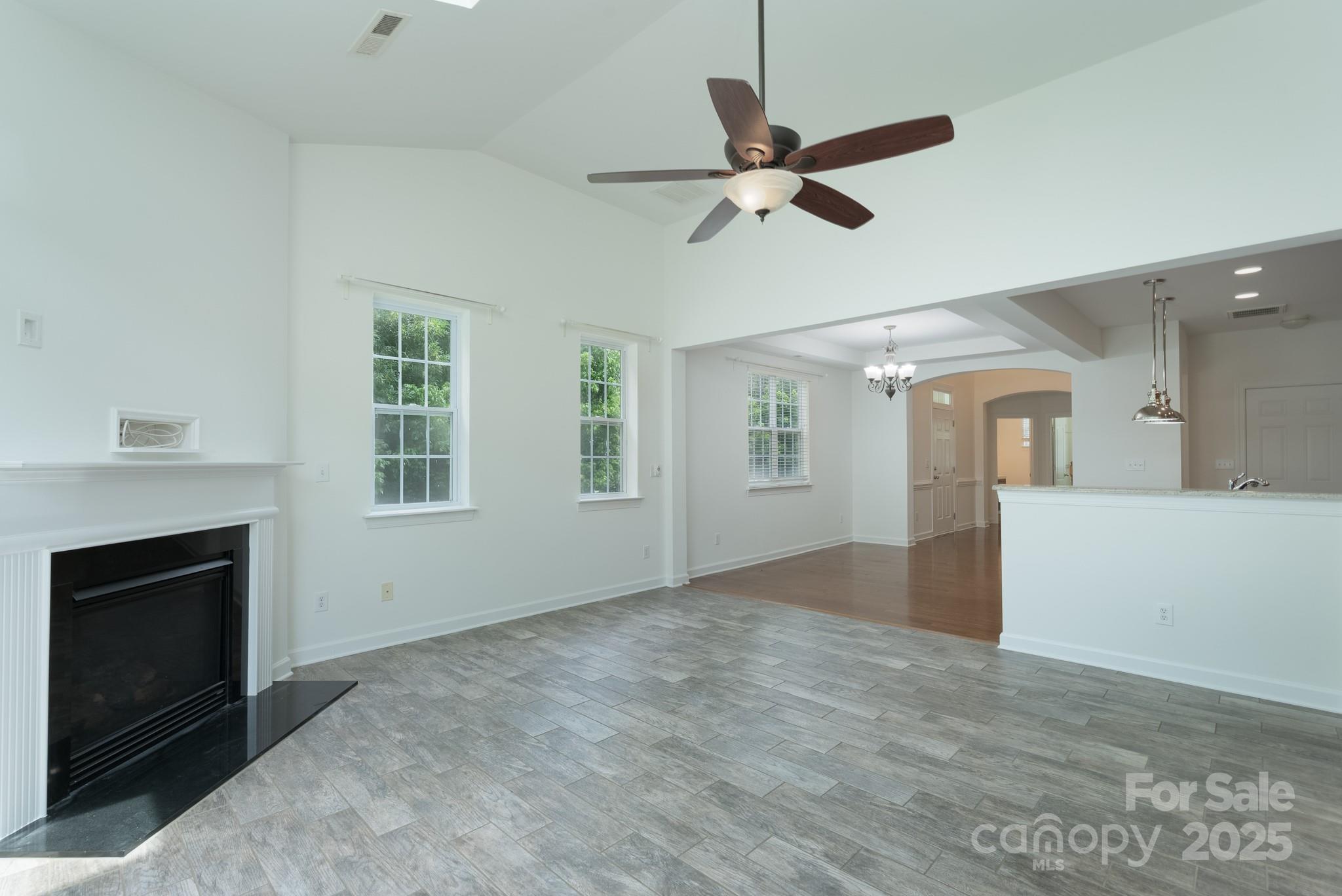 11945 Red Rust Lane Charlotte, NC 28277 - Photo 13 of 41 a view of an empty room with a fireplace and a window