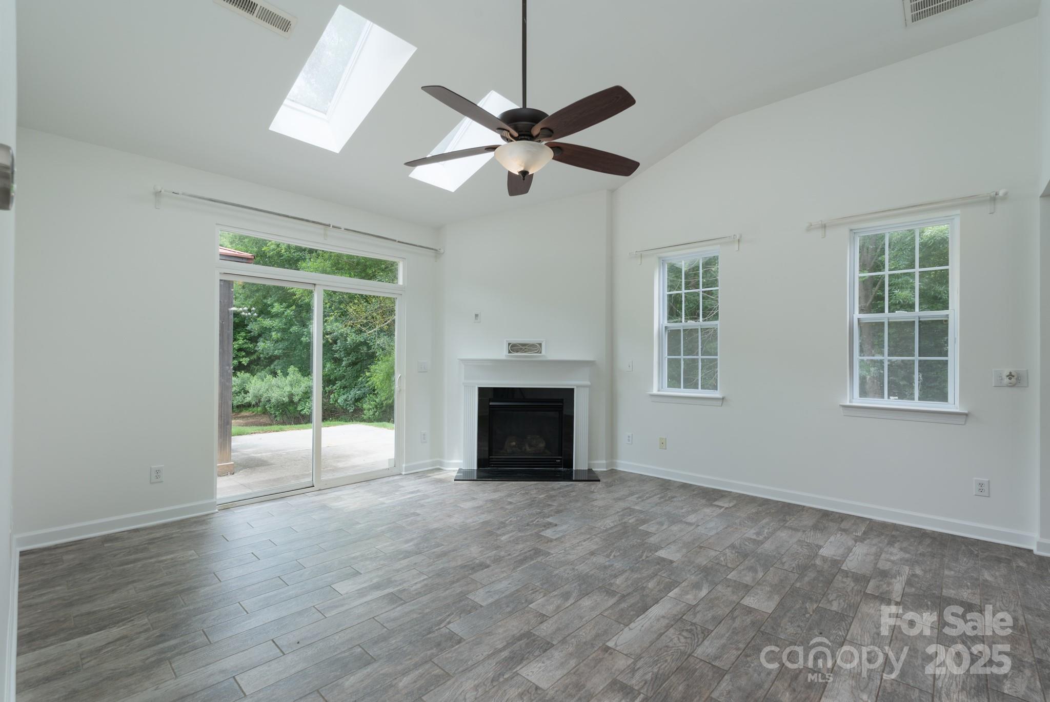 11945 Red Rust Lane Charlotte, NC 28277 - Photo 14 of 41 a view of livingroom with window fireplace and ceiling fan