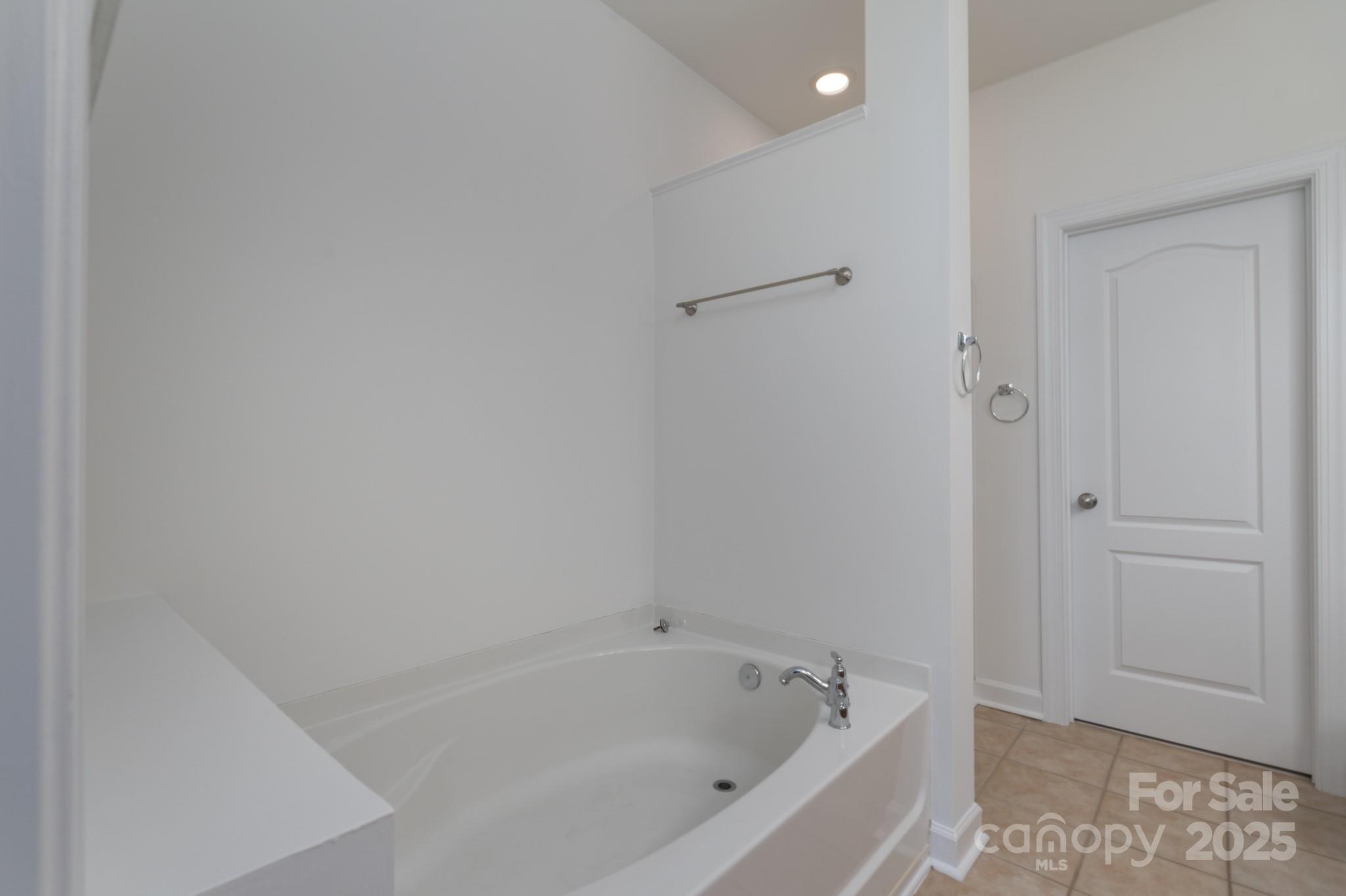 11945 Red Rust Lane Charlotte, NC 28277 - Photo 17 of 41 a white bath tub sitting next to a shower