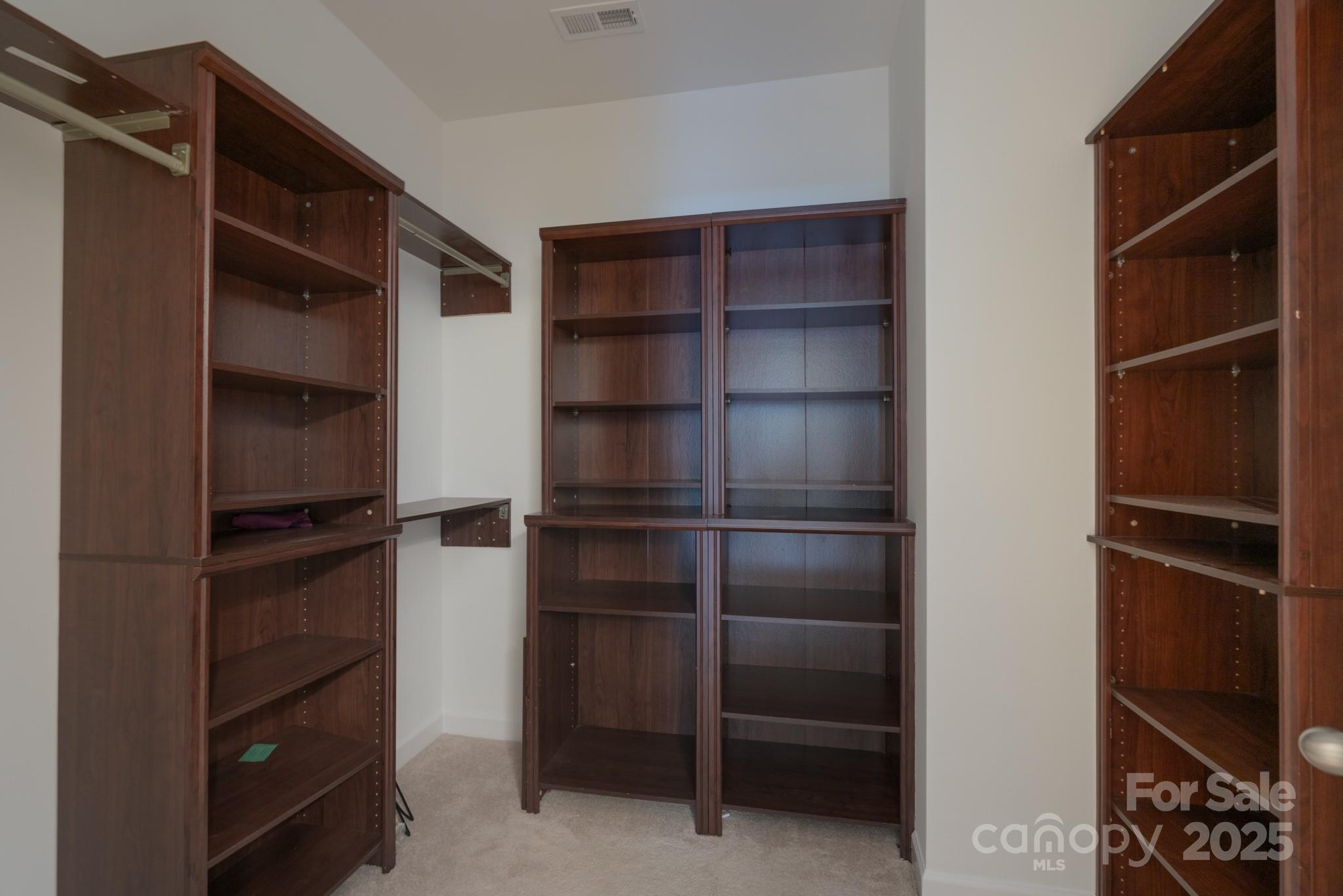 11945 Red Rust Lane Charlotte, NC 28277 - Photo 19 of 41 a view of walk in closet with empty racks