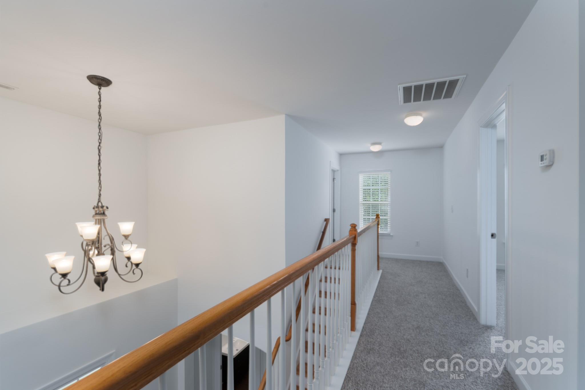 11945 Red Rust Lane Charlotte, NC 28277 - Photo 20 of 41 a view of a hallway view with chandelier