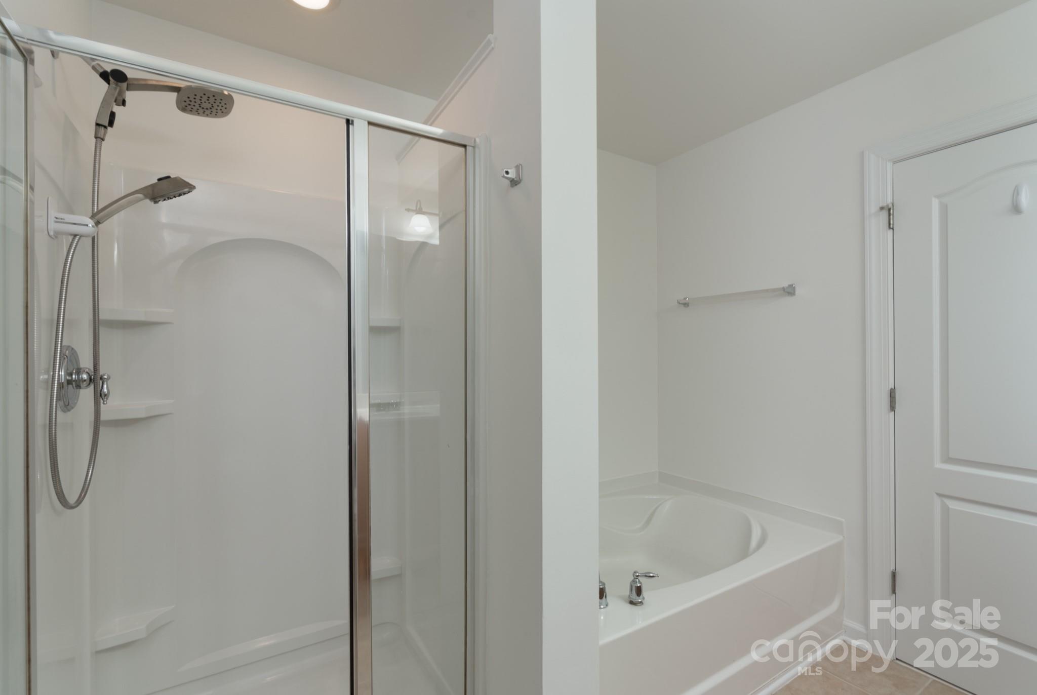 11945 Red Rust Lane Charlotte, NC 28277 - Photo 27 of 41 a bathroom with a bath tub and shower