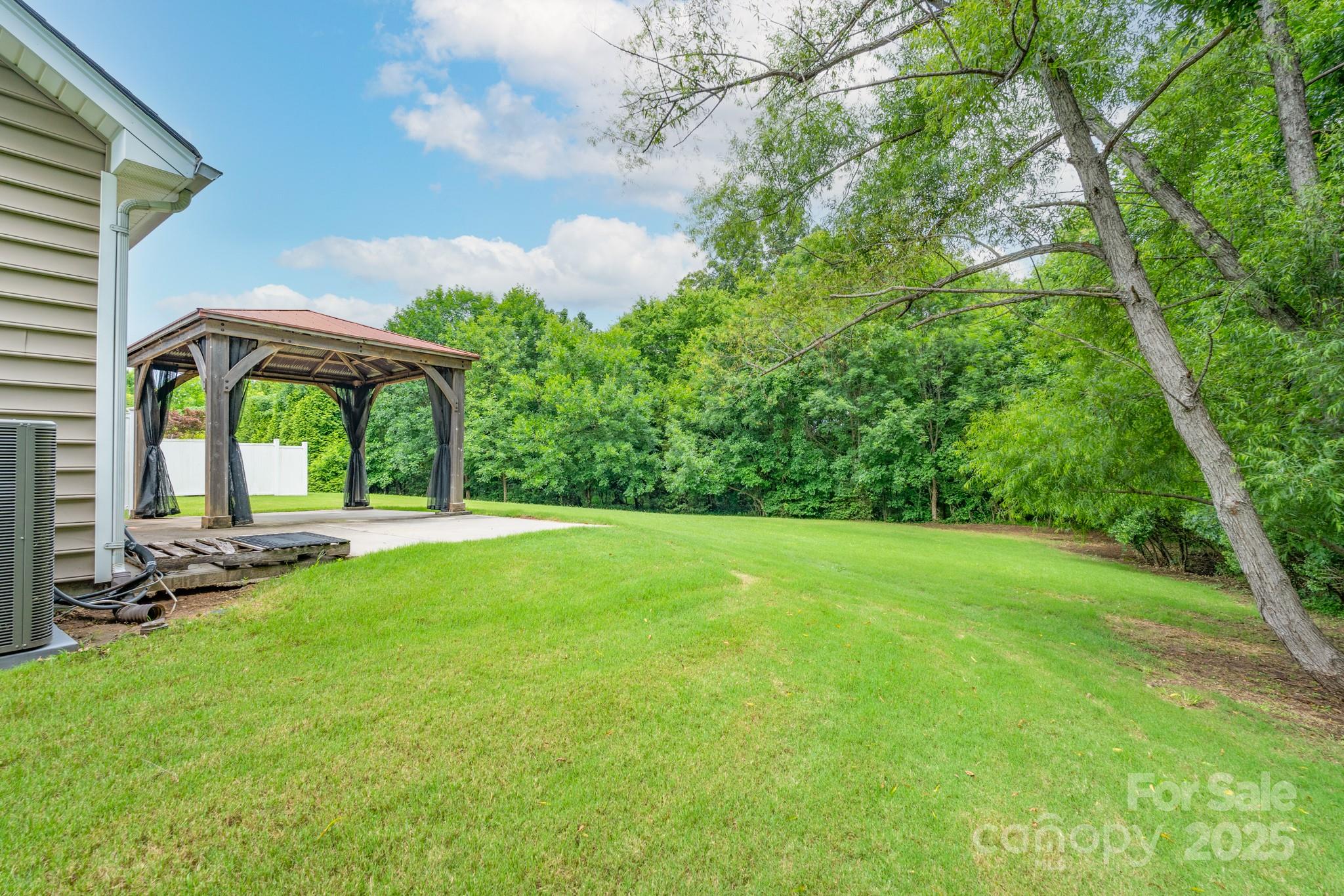 11945 Red Rust Lane Charlotte, NC 28277 - Photo 31 of 41 a view of a patio with a table and chairs under an umbrella