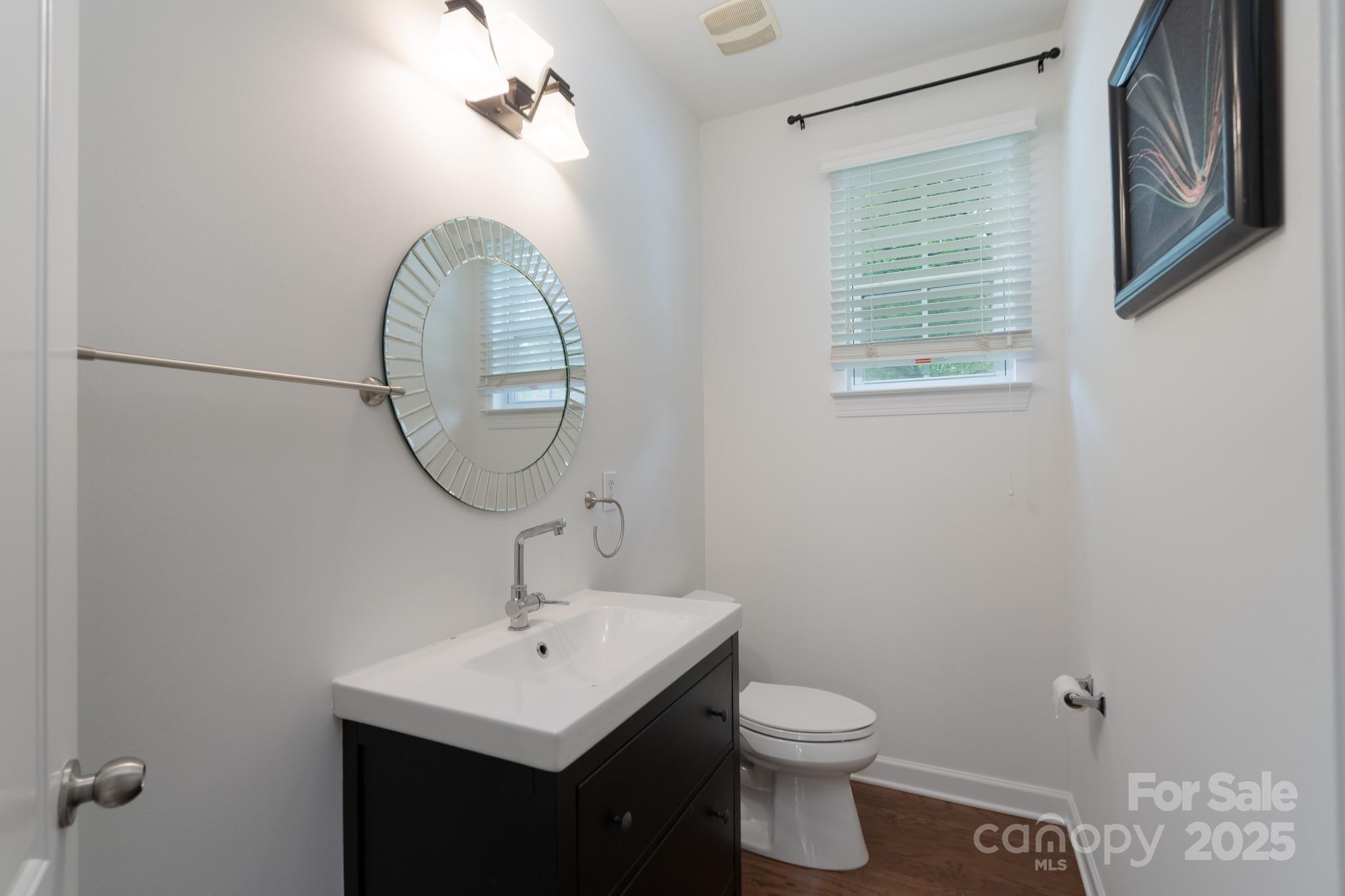 11945 Red Rust Lane Charlotte, NC 28277 - Photo 6 of 41 a bathroom with a toilet a sink and a mirror