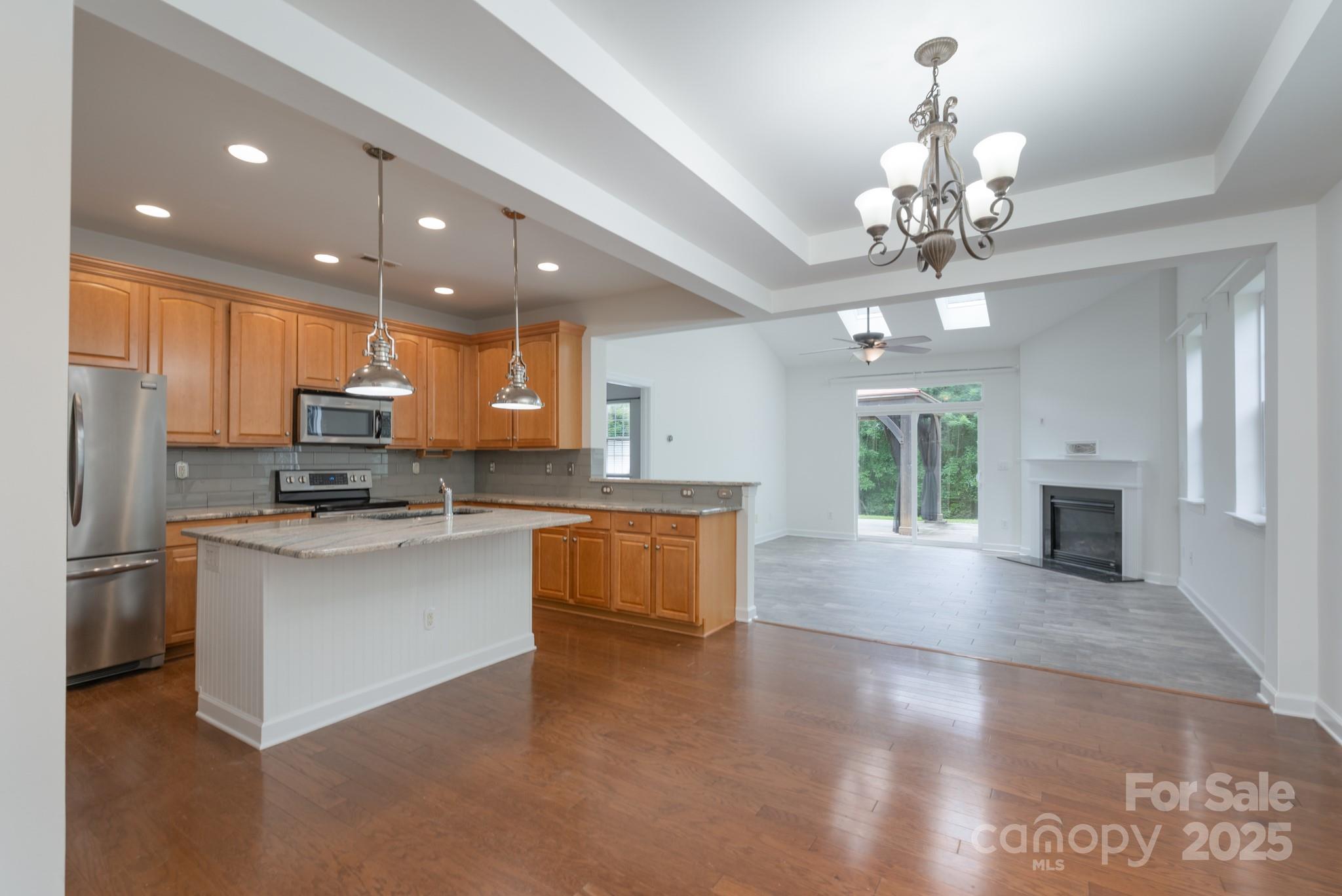11945 Red Rust Lane Charlotte, NC 28277 - Photo 8 of 41 a large kitchen with granite countertop a large counter top stainless steel appliances and cabinets