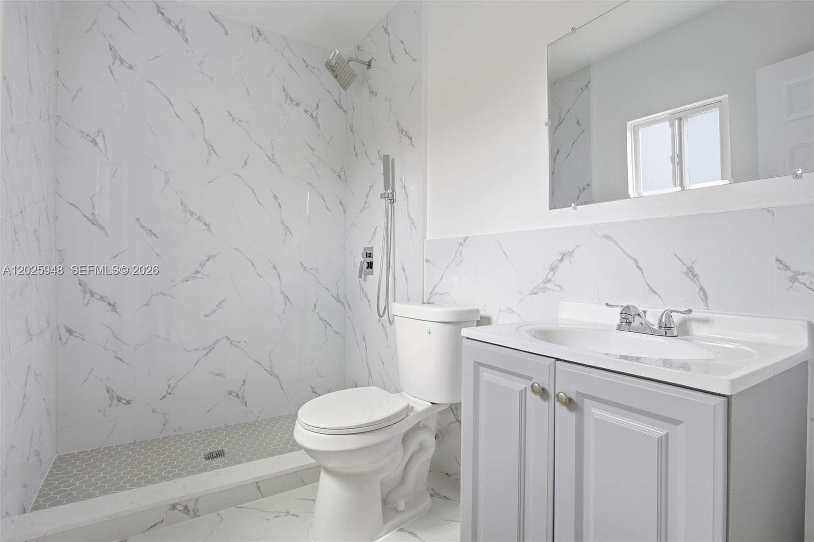 1745 Southwest 17th Street, Unit 2 Miami, FL 33145 - Photo 16 of 32 a bathroom with a sink toilet and vanity