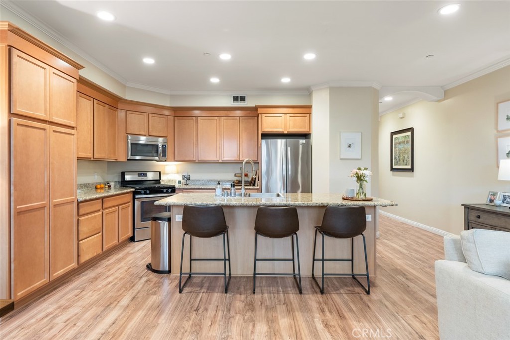 55 8th Street Templeton, CA 93465 - Photo 11 of 33 a kitchen with a sink dishwasher a dining table and chairs with wooden floor