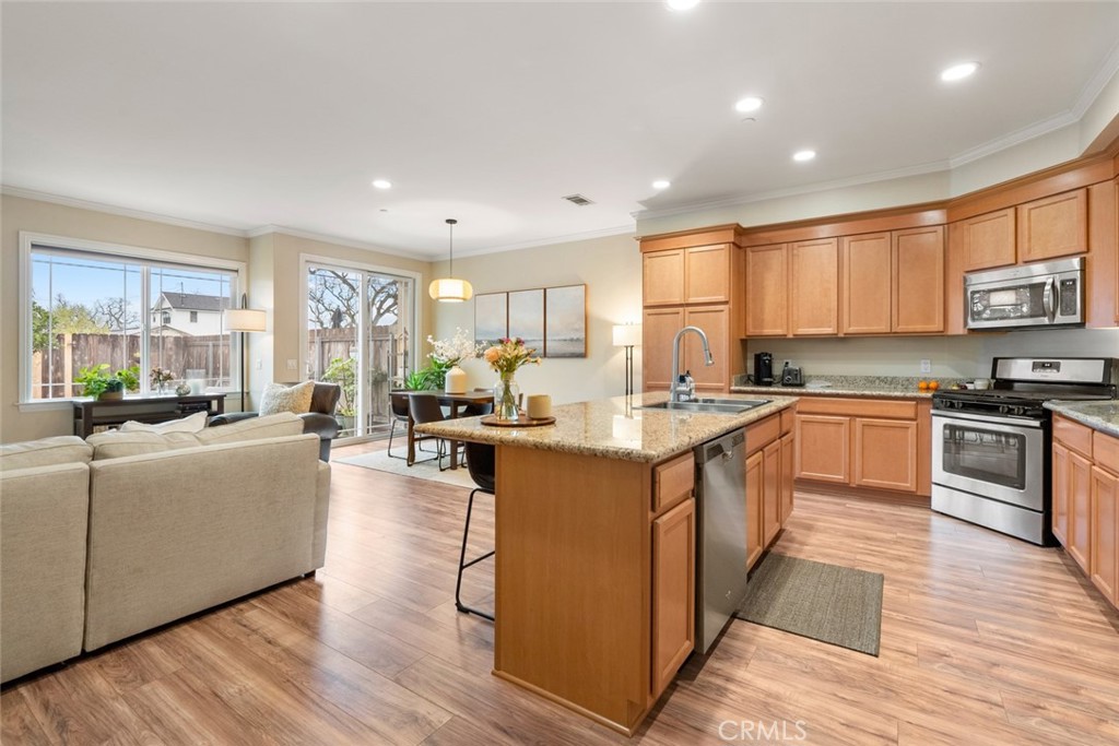 55 8th Street Templeton, CA 93465 - Photo 2 of 33 a large kitchen with stainless steel appliances granite countertop a stove a sink dishwasher a refrigerator and white cabinets with wooden floor