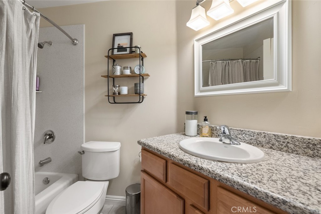 55 8th Street Templeton, CA 93465 - Photo 21 of 33 a bathroom with a granite countertop sink a toilet and a mirror