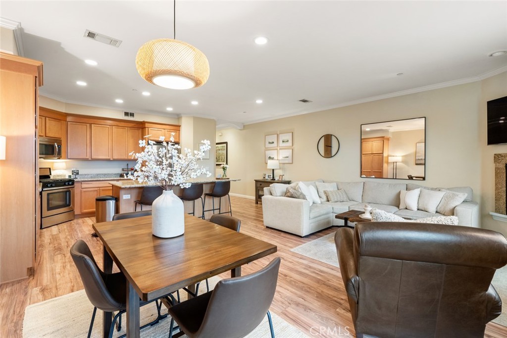 55 8th Street Templeton, CA 93465 - Photo 3 of 33 a living room with kitchen island furniture a kitchen view and a wooden floor