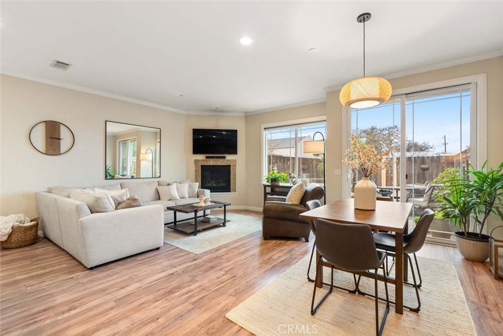 55 8th Street Templeton, CA 93465 - Photo 6 of 33 a living room with couches a fireplace and dining table with wooden floor