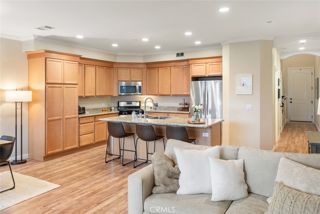 55 8th Street Templeton, CA 93465 - Photo 10 of 33 a kitchen with kitchen island granite countertop wooden floors and white cabinets
