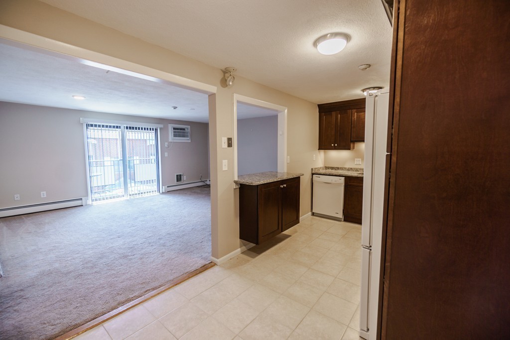 50 Colonial Drive, Unit 8 Andover, MA 01810 - Photo 7 of 25 an empty room with windows and cabinet