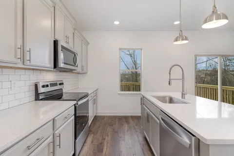 a view of a kitchen with a sink wooden floor and a kitchen