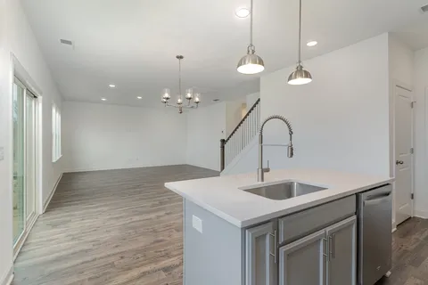a view of a kitchen with a sink and chandelier