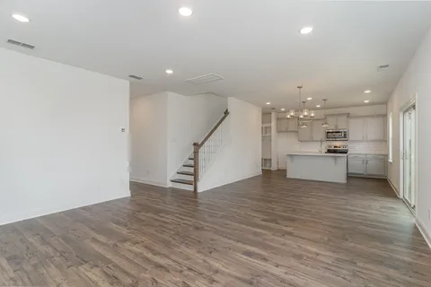 a kitchen with a refrigerator and white cabinets