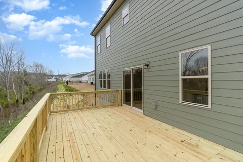 a view of a balcony with wooden floor and fence