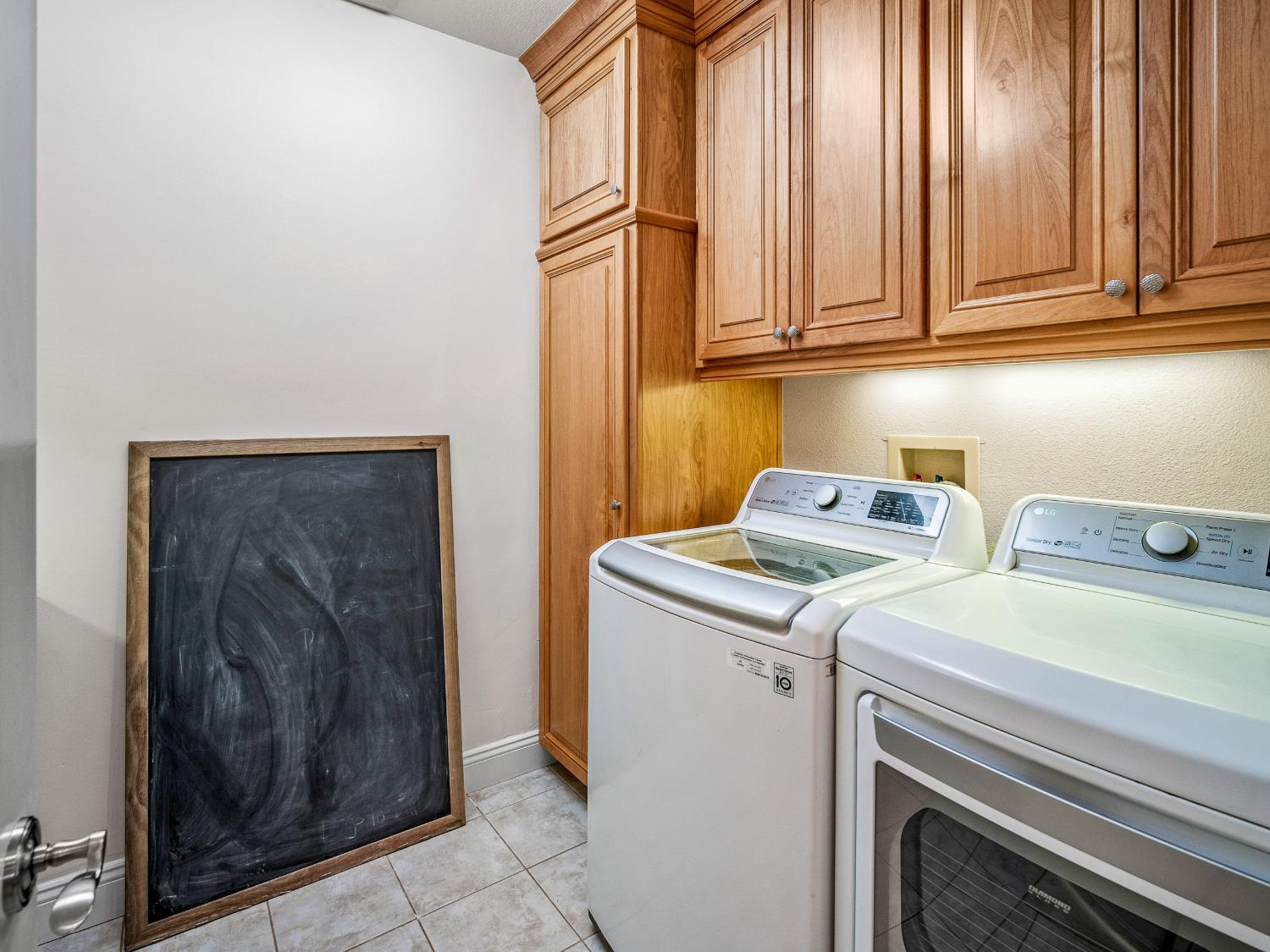 5080 Gold Hill Road Placerville, CA 95667 - Photo 29 of 63 Laundry room with lots of storage cabinets and a large folding counter.