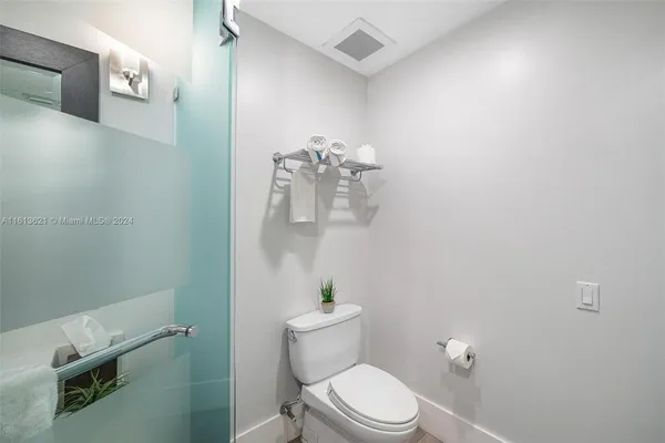 a white toilet sitting next to a bathroom sink