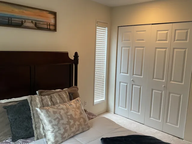 a bedroom with a bed and a night stand