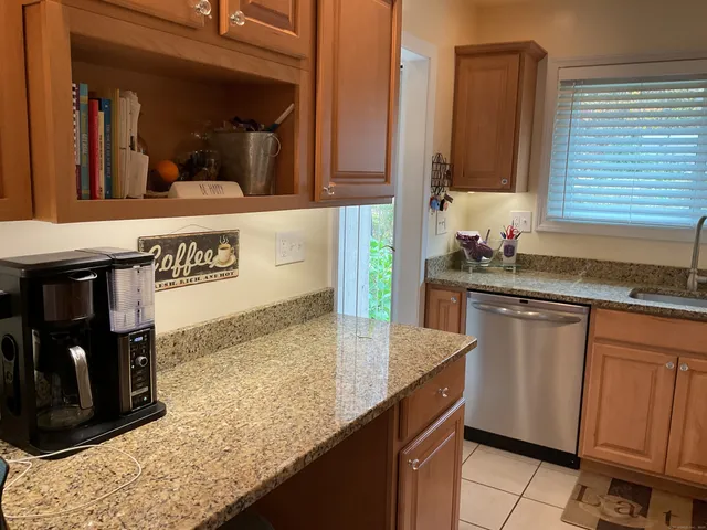 a kitchen with stainless steel appliances granite countertop a sink and a stove