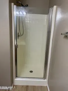 a bathroom with a glass shower door and a mirror