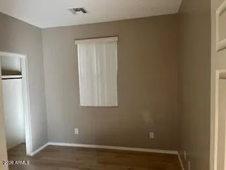 a view of small space with wooden floor and a window