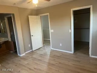 an empty room with wooden floor and closet