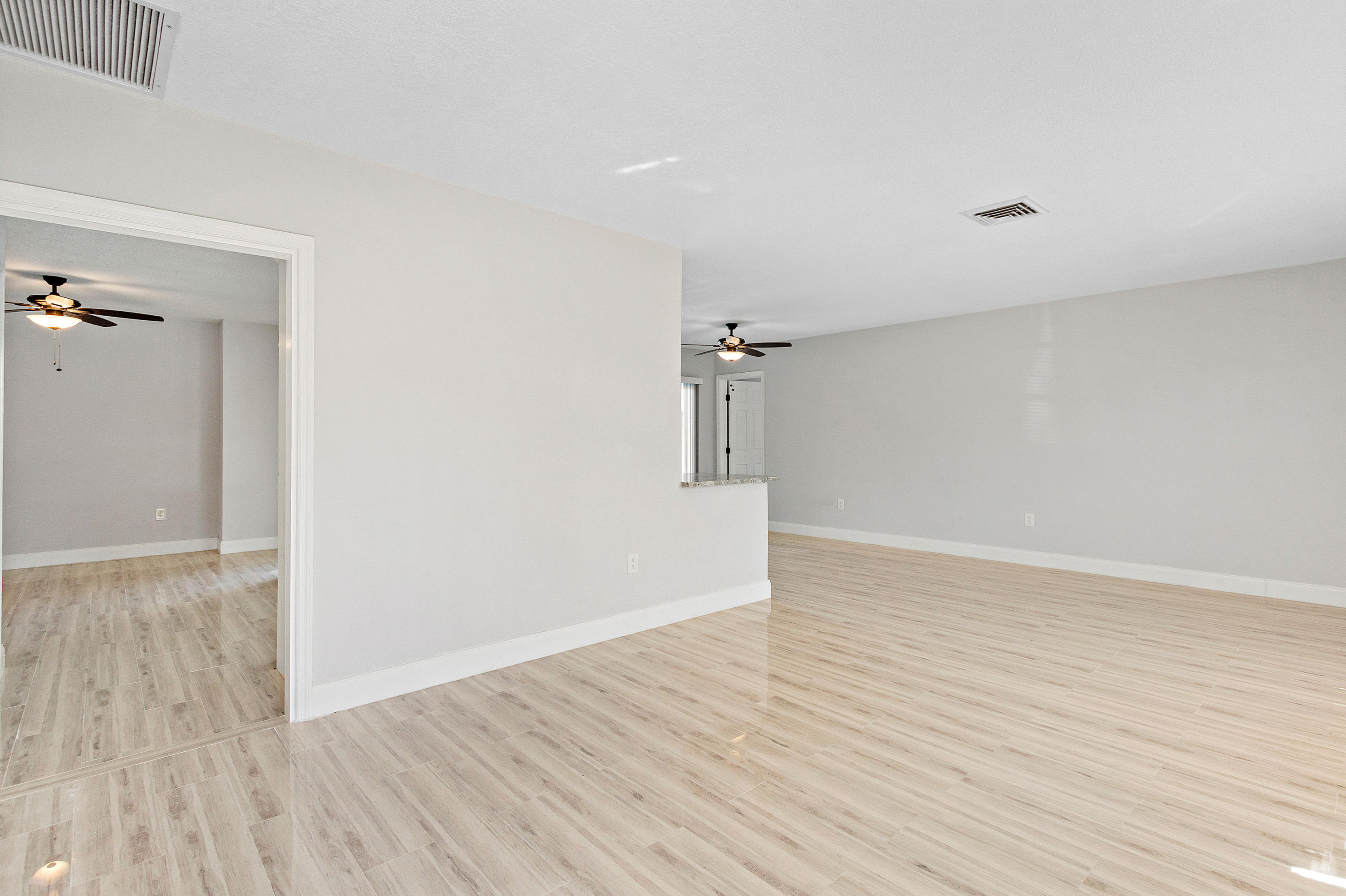 871 Northwest 7th Street Boca Raton, FL 33486 - Photo 3 of 21 a view of a room with wooden floor