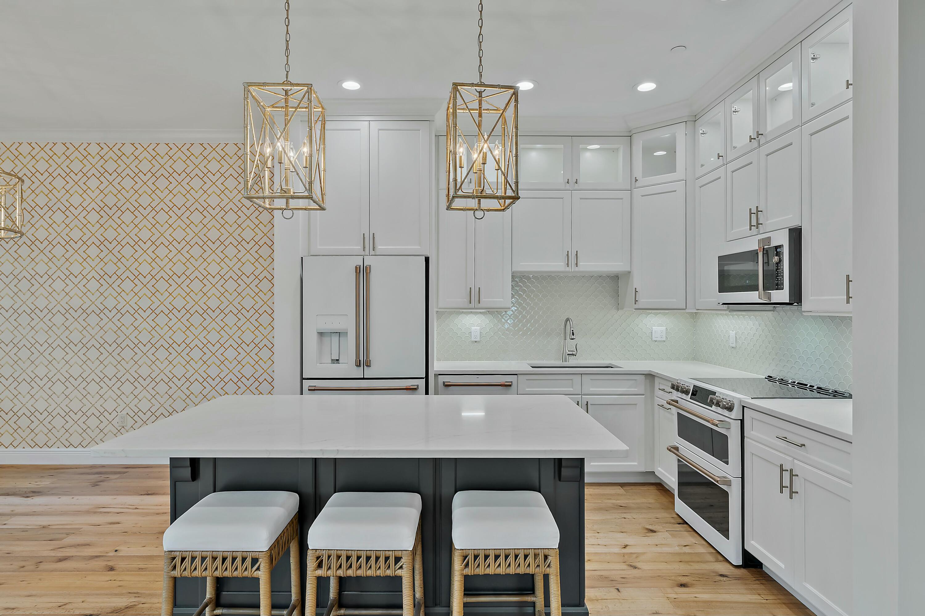 310 Inlet Waters Circle Jupiter, FL 33477 - Photo 5 of 32 a kitchen with stainless steel appliances granite countertop a stove a sink and a refrigerator