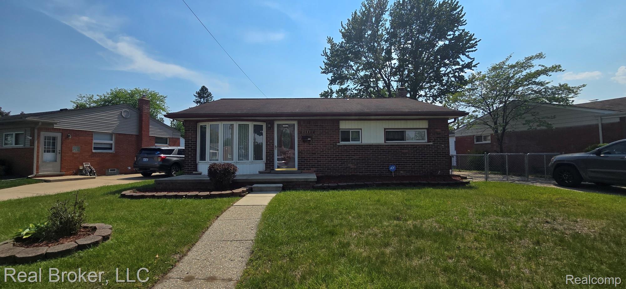 Brick ranch-style residence featuring a prominent bay window and an inviting front walkway